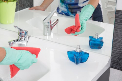 Trained carpet cleaning technician using protective gloves and covers
